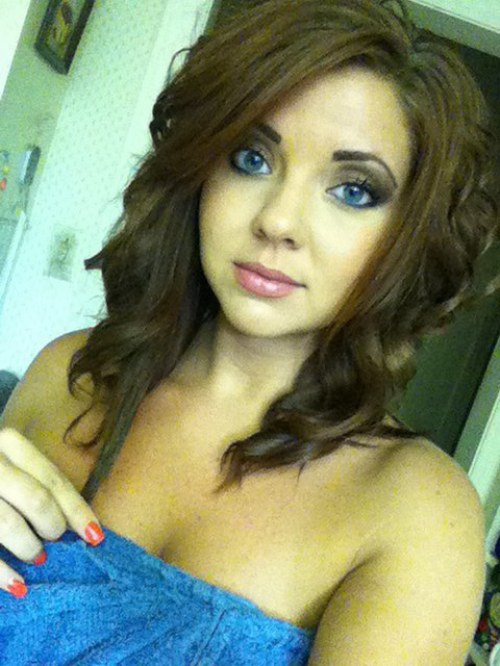 Gorgeous light-eyed brunette with juicy lips and sexy hot body takes selfie in blue towel
