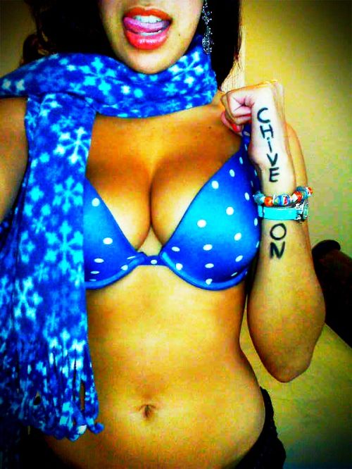 Brunette with Chive On written on hand, supple bouncy boobs, flat abs, and hot sexy body sticks out tongue and takes selfie in blue bra and scarf