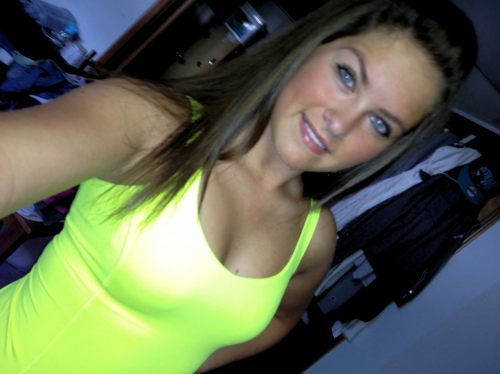 Pretty light-eyed brunette with perky juicy boobs and supple sexy hot body takes selfie in neon green top
