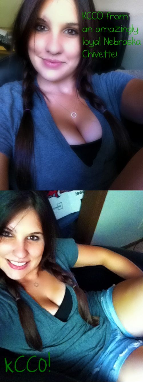 Pretty brunette with braided pigtails, supple juicy big boobs, and hot sexy voluptuous body takes selfie in cleavage showing black/gray top and blue shorts