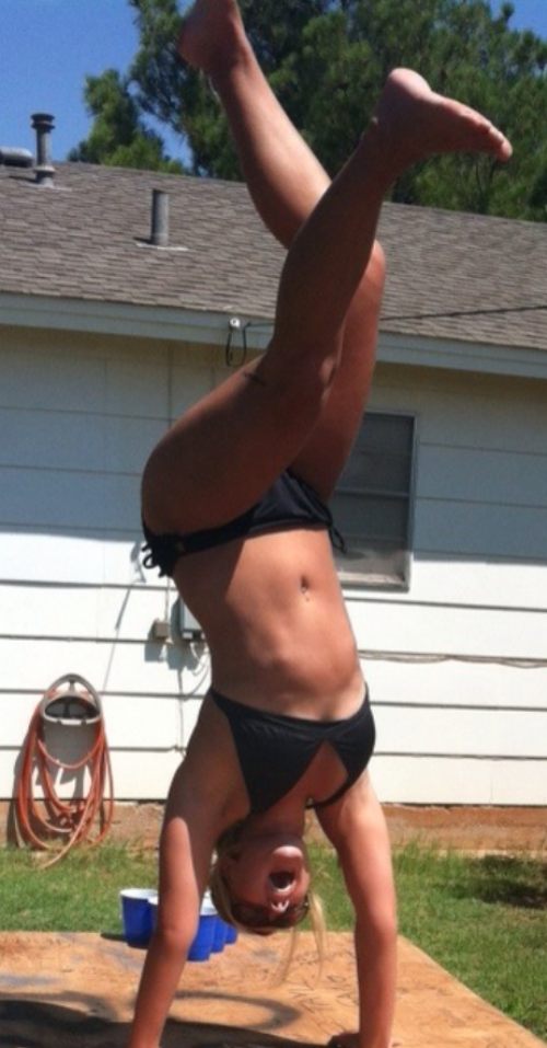 lady in black bikini standing on her hands with cool sun glasses