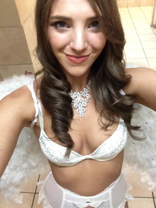 Brunette with perky boobs and slim sexy body takes selfie in white lace lingerie