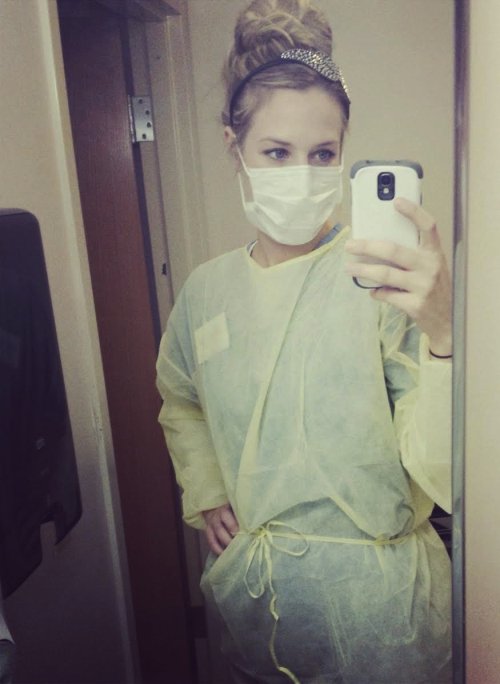 Blonde takes selfie in yellow surgical mask and attire