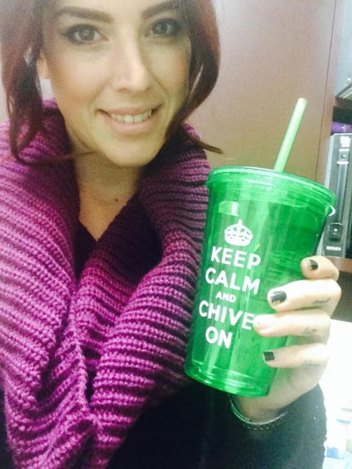 Brunette with green KCCO glass takes selfie in magenta scarf and black top