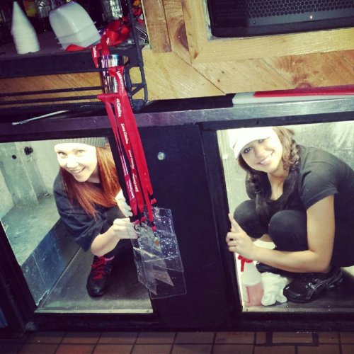 Pretty brunettes in black clothes clean and pose under the sink