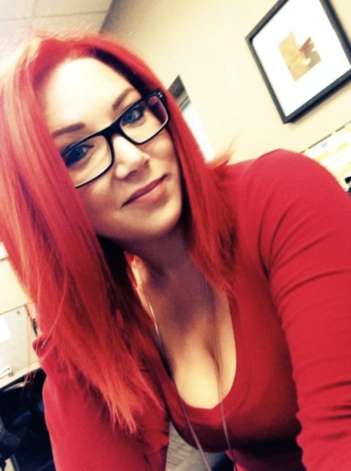 Girl with red dyed hair and big bouncy knockers takes selfie in cleavage showing red top