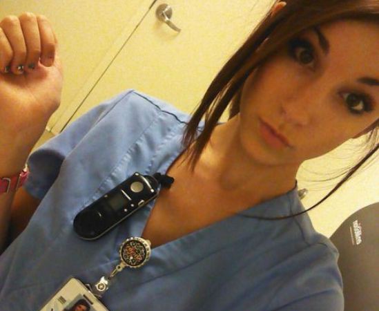 Pretty brunette with slim sexy body takes selfie in blue nurse/doctor uniform