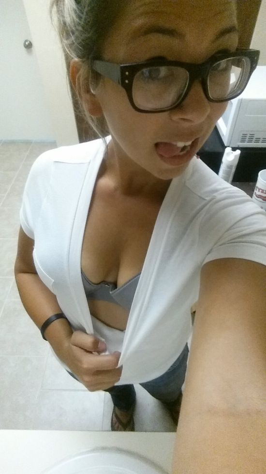 Brunette in glasses pulls white top to selfie perky boobs and cleavage in grey bra