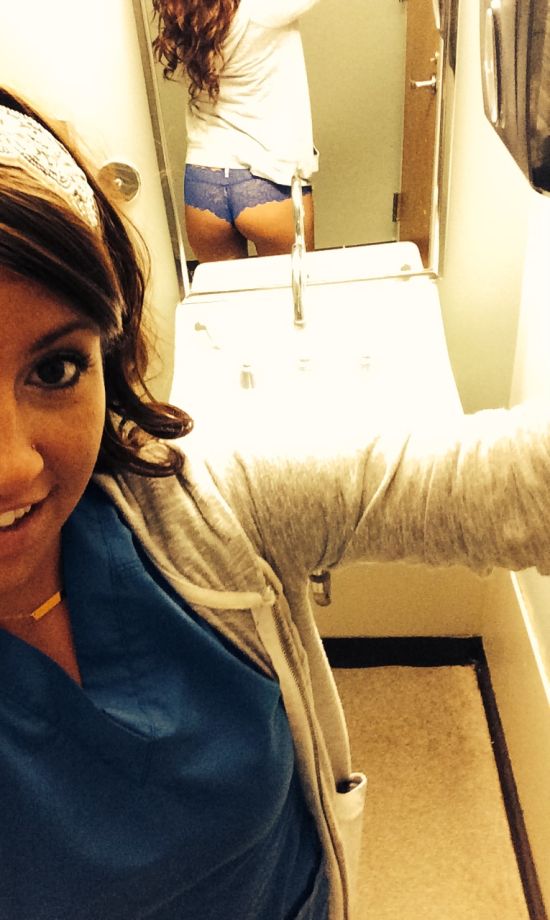 Brunette with perky boobs and supple juicy butt cheeks takes selfie in blue top, grey jacket, and lace panties
