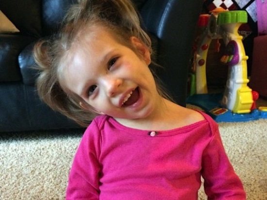 Caroline Wooley smiling in a pink shirt