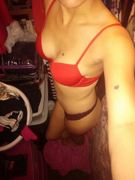 Girl with perky boobs and slim body takes selfie in red bra and red/black panties