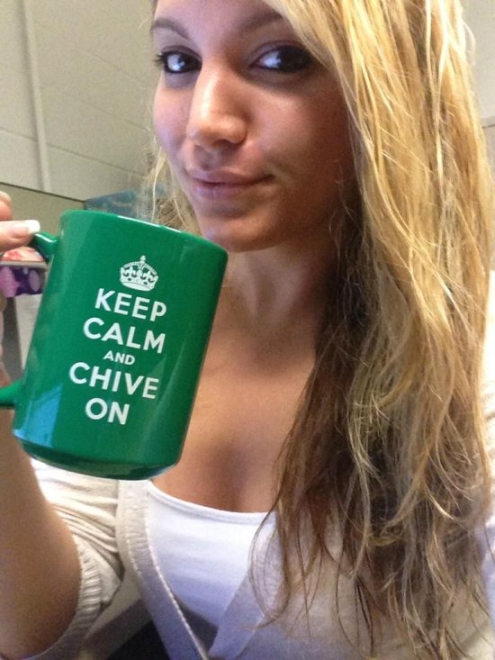 blonde girl holding KCCO green coffee mug