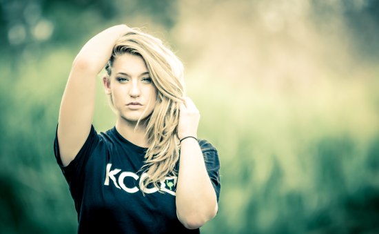 girl in KCCO black tshirt with long blonde hair