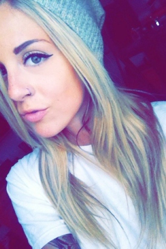 blonde girl with beanie on and nose ring, wearing white t-shirt