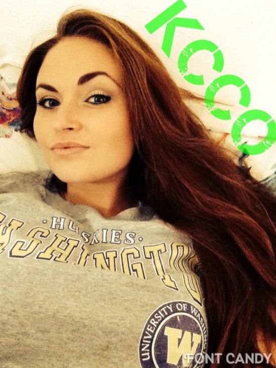 Long-haired brunette in Washington Huskies shirt and KCCO in green on the side