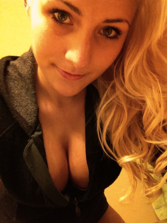 blonde girl in black hoodie showing cleavage