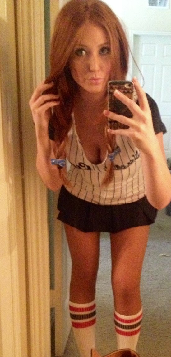 girl in sexy baseball out fit showing cleavage with red pigtails