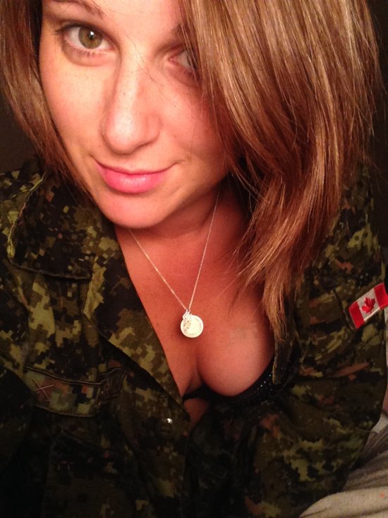 Girl with short hair in camo jacket showing cleavage