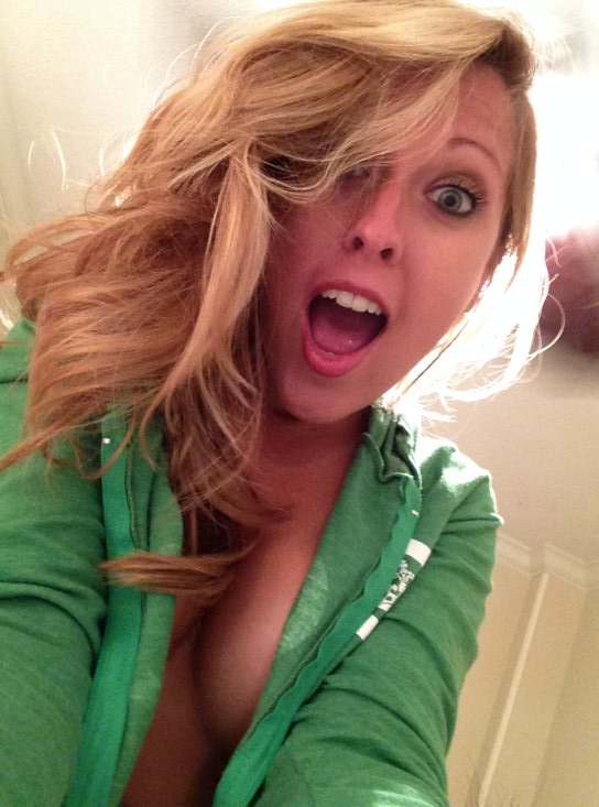 girl in green jacket unzipped with cleavage showing