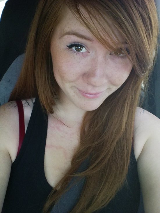 red head in car with black tank top