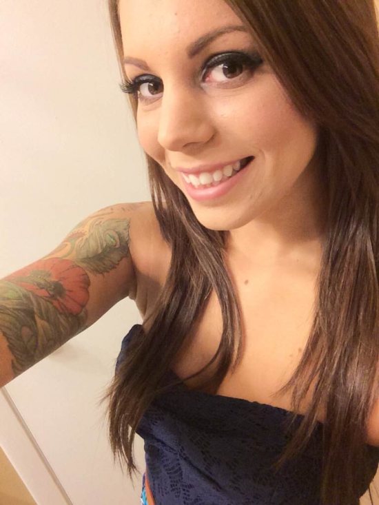 selfie of girl in tube top with sleeve tattoo