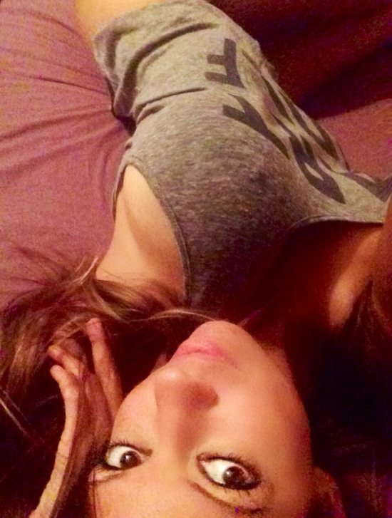 POV of girl laying on bed in grey tank top
