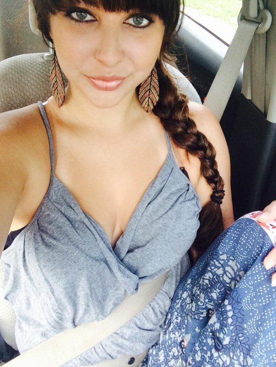 Car selfie of girl with long braid and grey tank top with leaf earrings