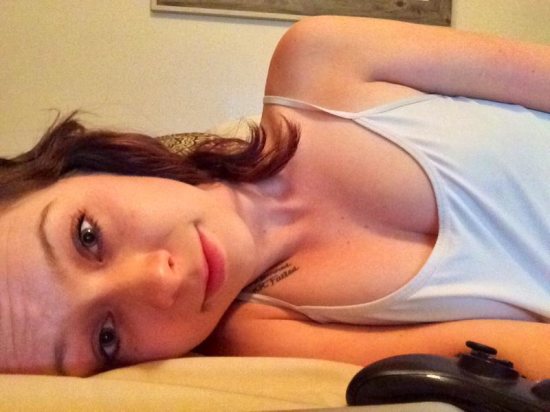 girl laying down next to video game controller