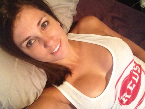 Happy brunette woman shows her boobs while taking her selfie
