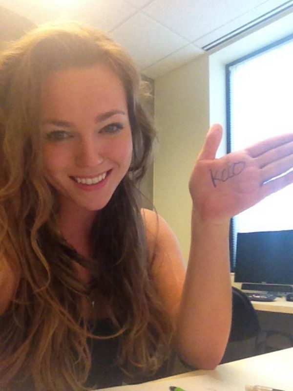 Girl smiling with KCCO on her hand