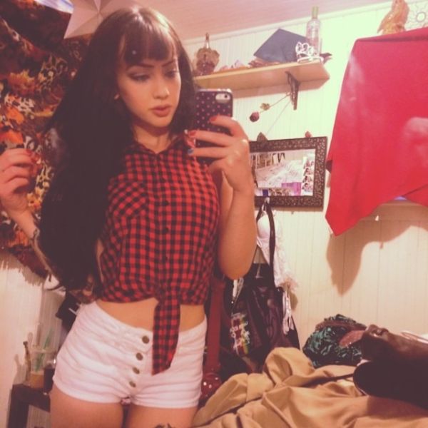 Girl in black and red flannel with white shorts