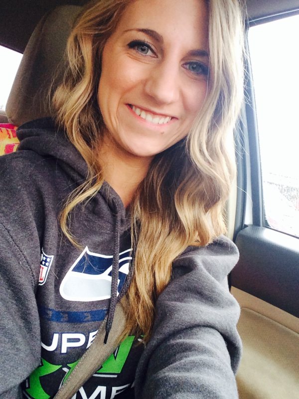 Girl smiling in car with grey seahawks hoodie