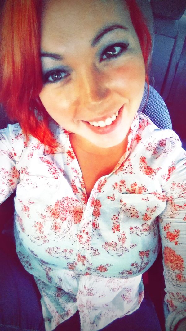 Girl with red hair and floral shirt