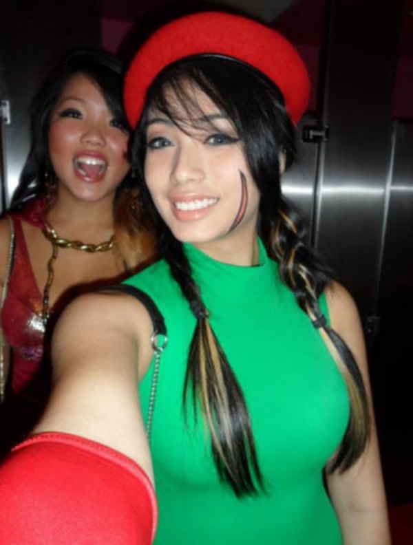 Girl in green shirt and red hat