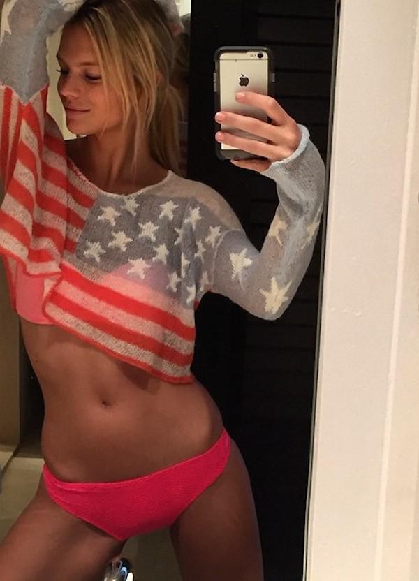 Pretty blonde with slim sexy curvy hot body takes selfie in pink bra and panties and stars and stripes crop top