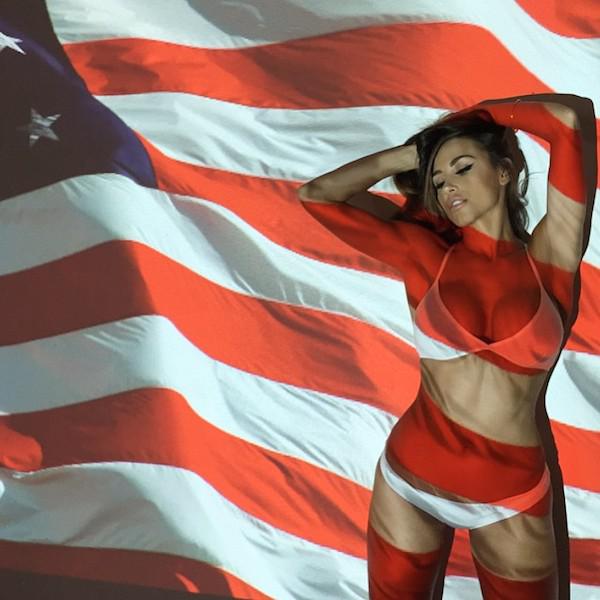 Pretty brunette with perky juicy boobs, flat abs, and hot voluptuous curvy sexy body poses with American flag in white bikini
