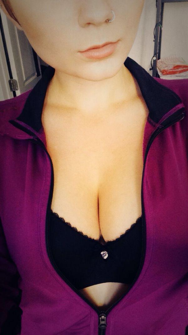 Girl with nose ring and perky juicy boobs takes selfie in black bra and cleavage showing violet jacket