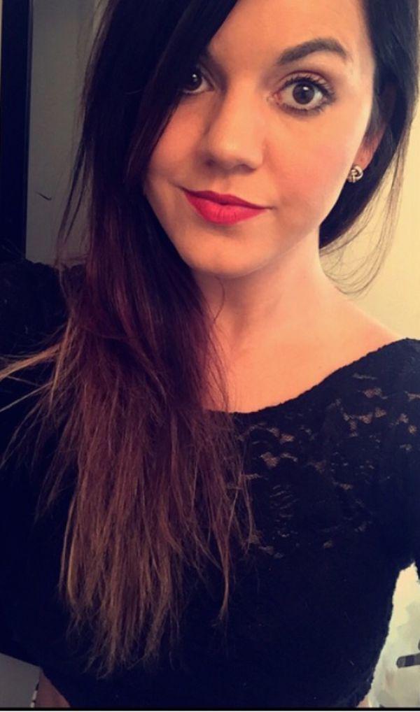 Pretty brunette with red lips takes selfie in black lace top