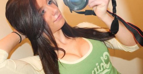 Pretty brunette with perky juicy boobs poses with camera and takes selfie in white/green Chivette top