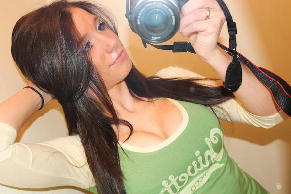 Pretty brunette with perky juicy boobs poses with camera and takes selfie in white/green Chivette top