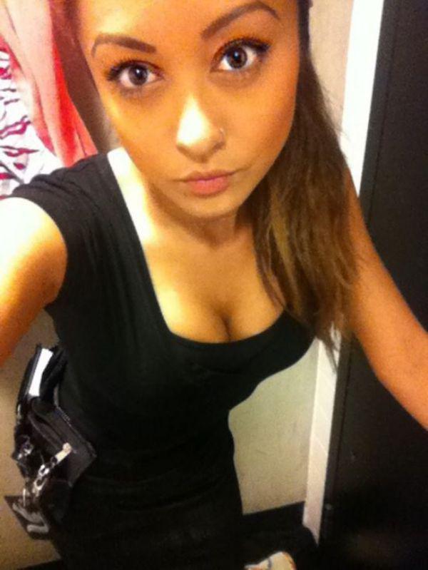 Pretty brunette with perky juicy boobs, nose ring, and slim sexy hot body takes selfie in cleavage showing tight black dress