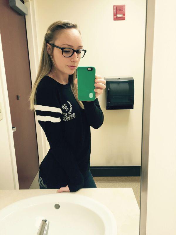 cute chick with poses in black sweatshirt from PINK while taking sexy eyeglasses selfie