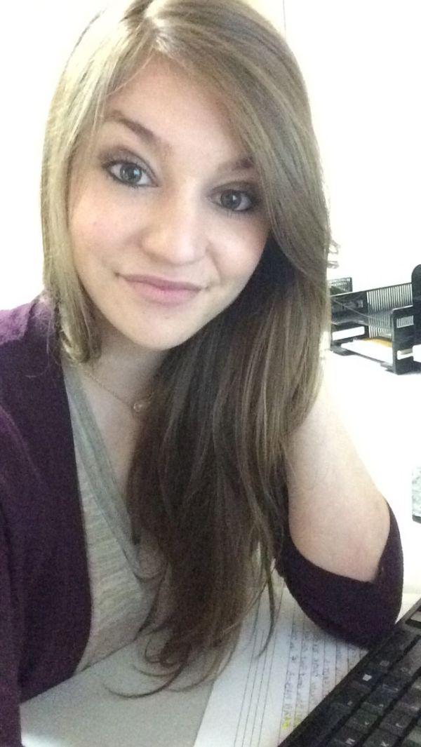 gorgeous chick with silky golden hair clicks sexy eyes selfie in dark purple color top in office