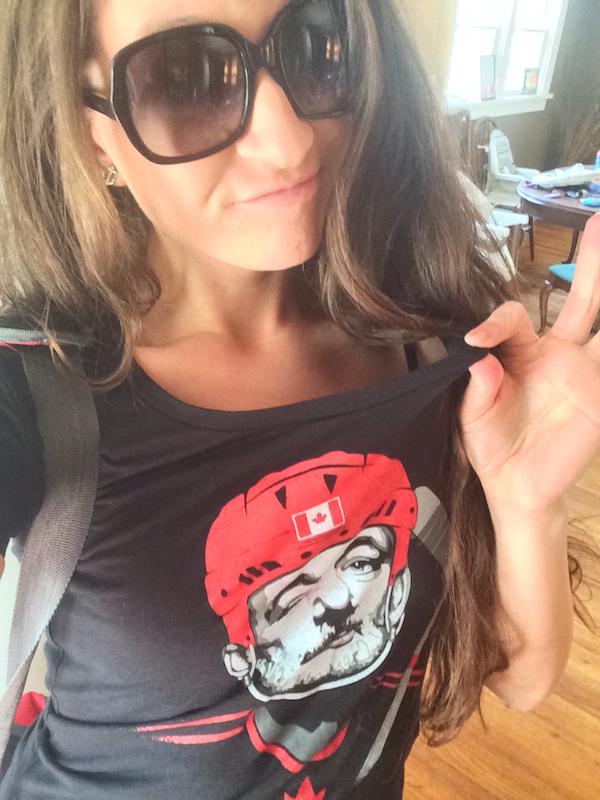 young cheerful girl poses in black BILL MURRAY face print top to click selfie with cool shades