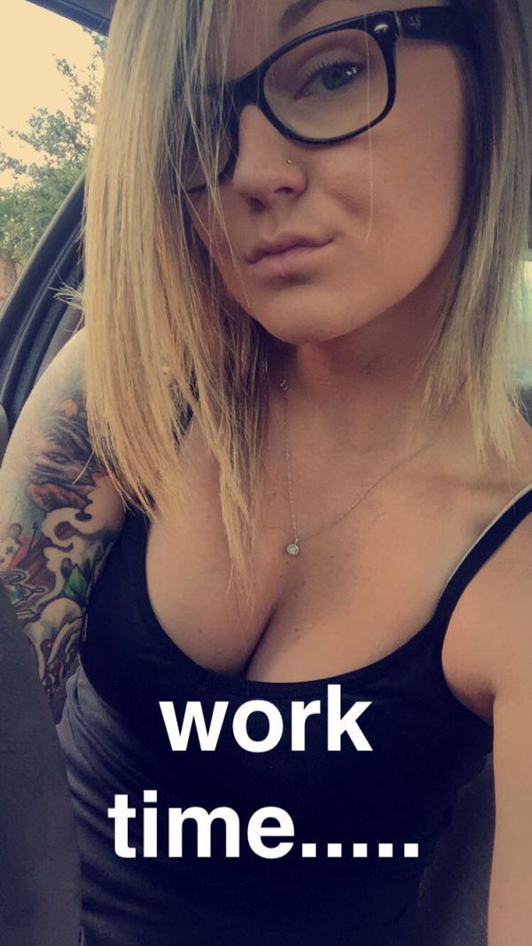 pretty girl takes sexy boobs selfie with black frame eyeglasses and trendy arm taoo with caption - WORK TIME