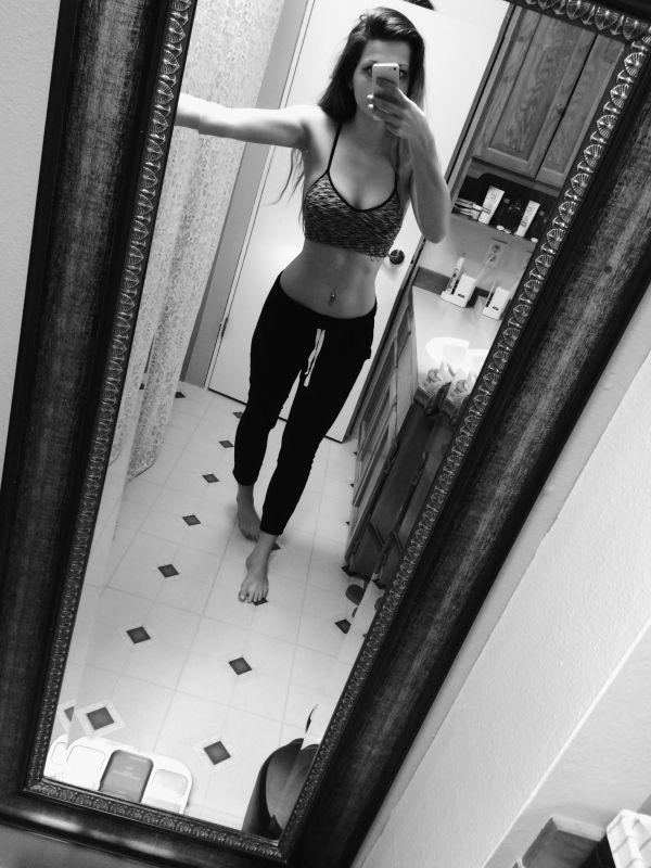 Hot gal takes a sexy black and white selfie in the bathroom, showing off her navel ring
