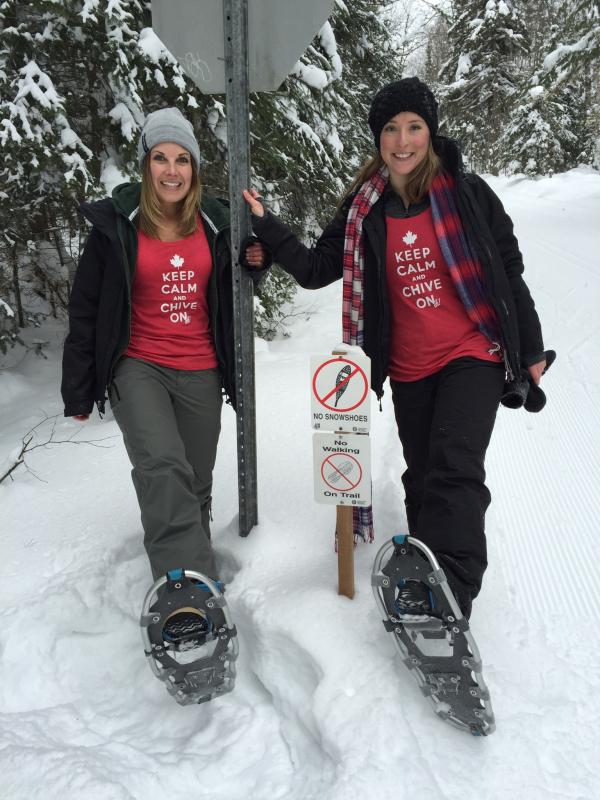 Hot mature women wearing KEEP CALM AND CHIVE ON printed pink top,black winter jacket,woollen cap and ski shoes