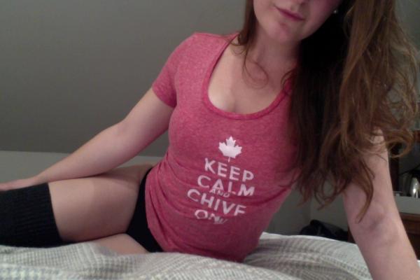 Woman wearing KEEP CALM AND CHIVE ON printed pink top,wearing black lingerie and black stockings