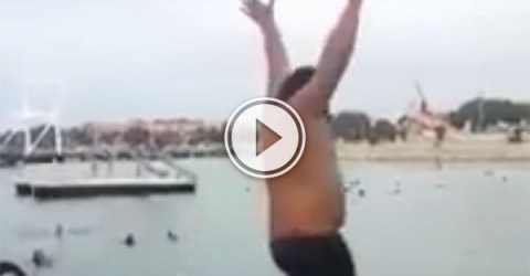 Man jumps into a lake with a ball and ball rockets up (Video)