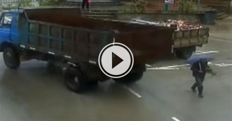 Near miss between truck and man in China (Video)